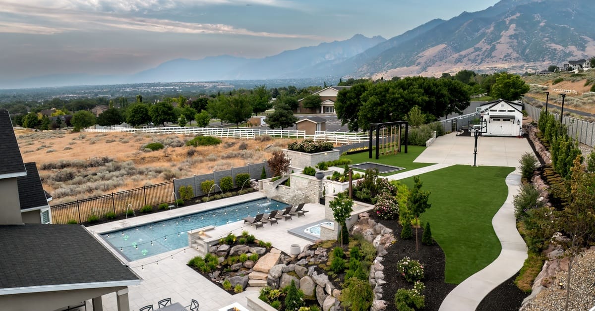 A gloomy day in Salt Lake City overlooking a backyard pool. The hot tub is on a higher level than the pool.